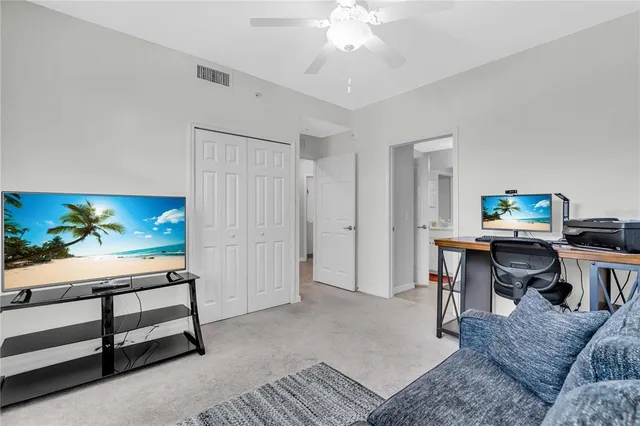 a bedroom with bed and a chandelier