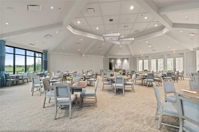 a view of a house with swimming pool and sitting area