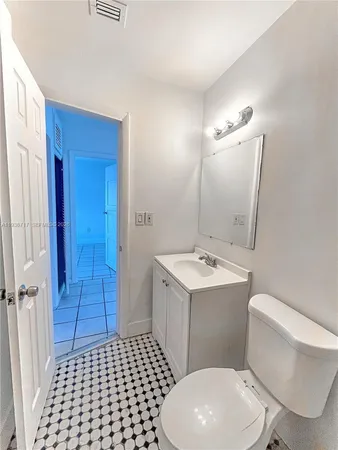 a bathroom with a sink a toilet a mirror and vanity