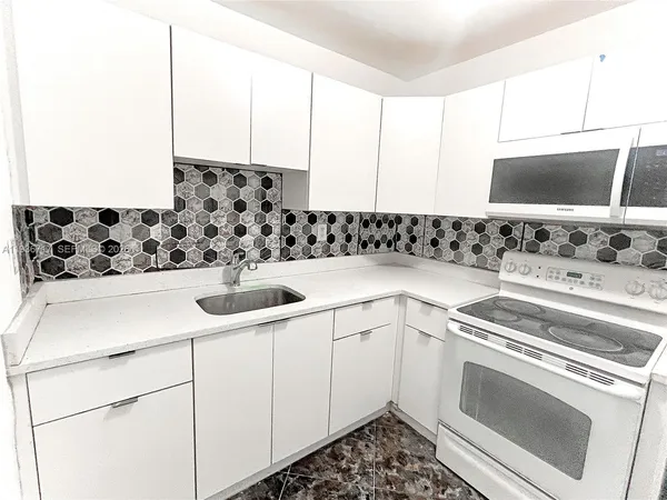 a kitchen with a sink stove and cabinets