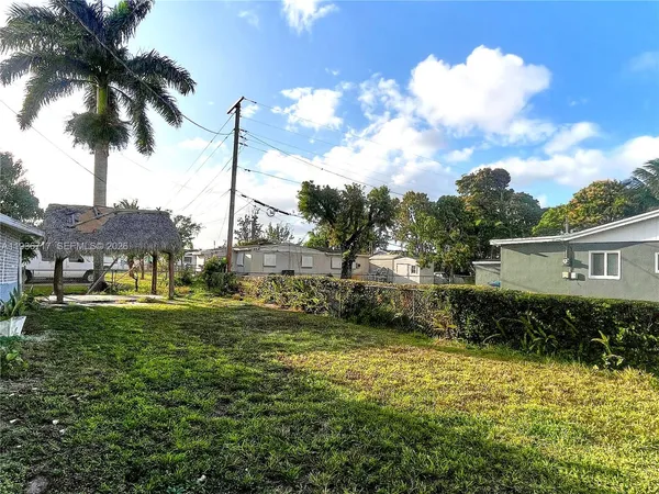 a backyard of a house with table and chairs