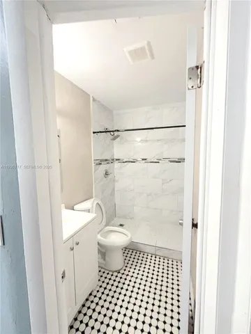 a bathroom with a toilet and a shower