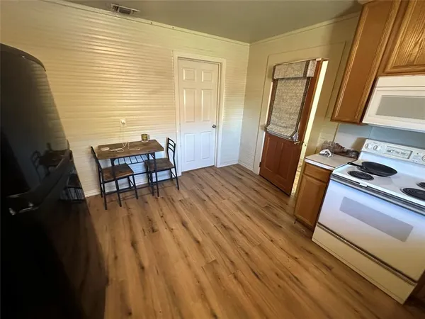 a view of a livingroom with furniture and wooden floor