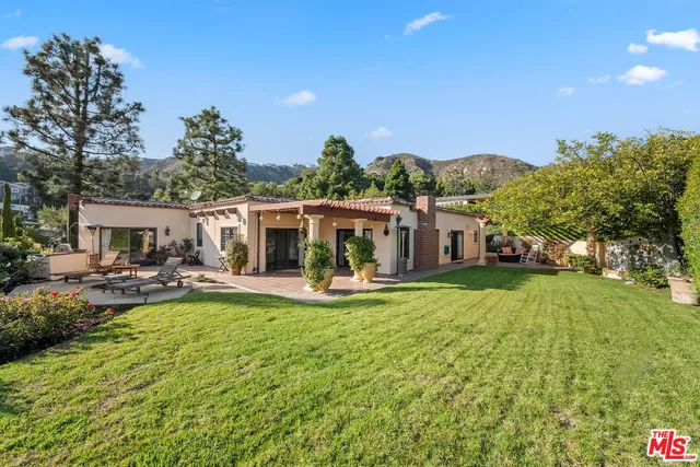 a view of a house with backyard porch and sitting area
