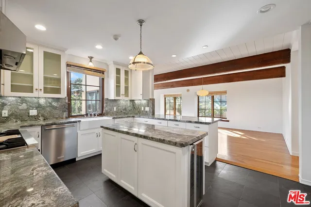 a kitchen with stainless steel appliances granite countertop stove top oven and refrigerator