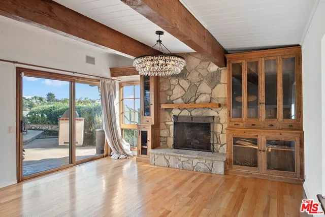a view of a livingroom with an entryway and fireplace