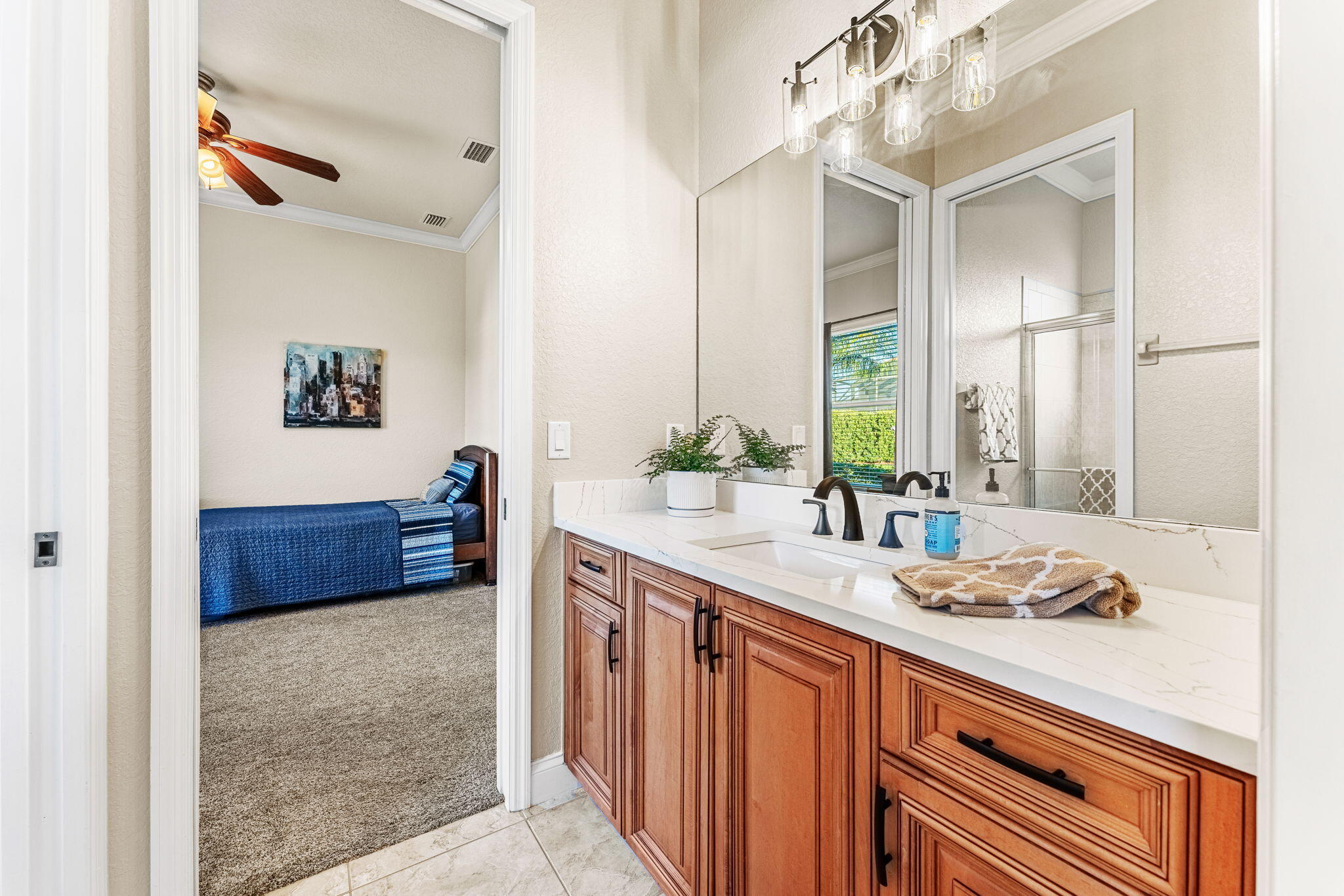 5139 Duson Way Rockledge, FL 32955 - Photo 29 of 48 a spacious bathroom with a granite countertop sink a mirror and a shower