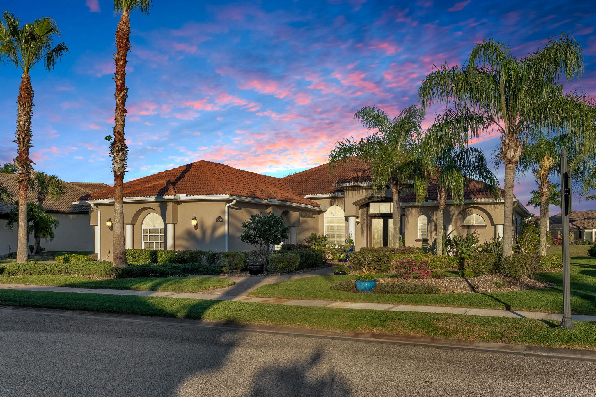 5139 Duson Way Rockledge, FL 32955 - Photo 48 of 48 a front view of a house with a yard and potted plants