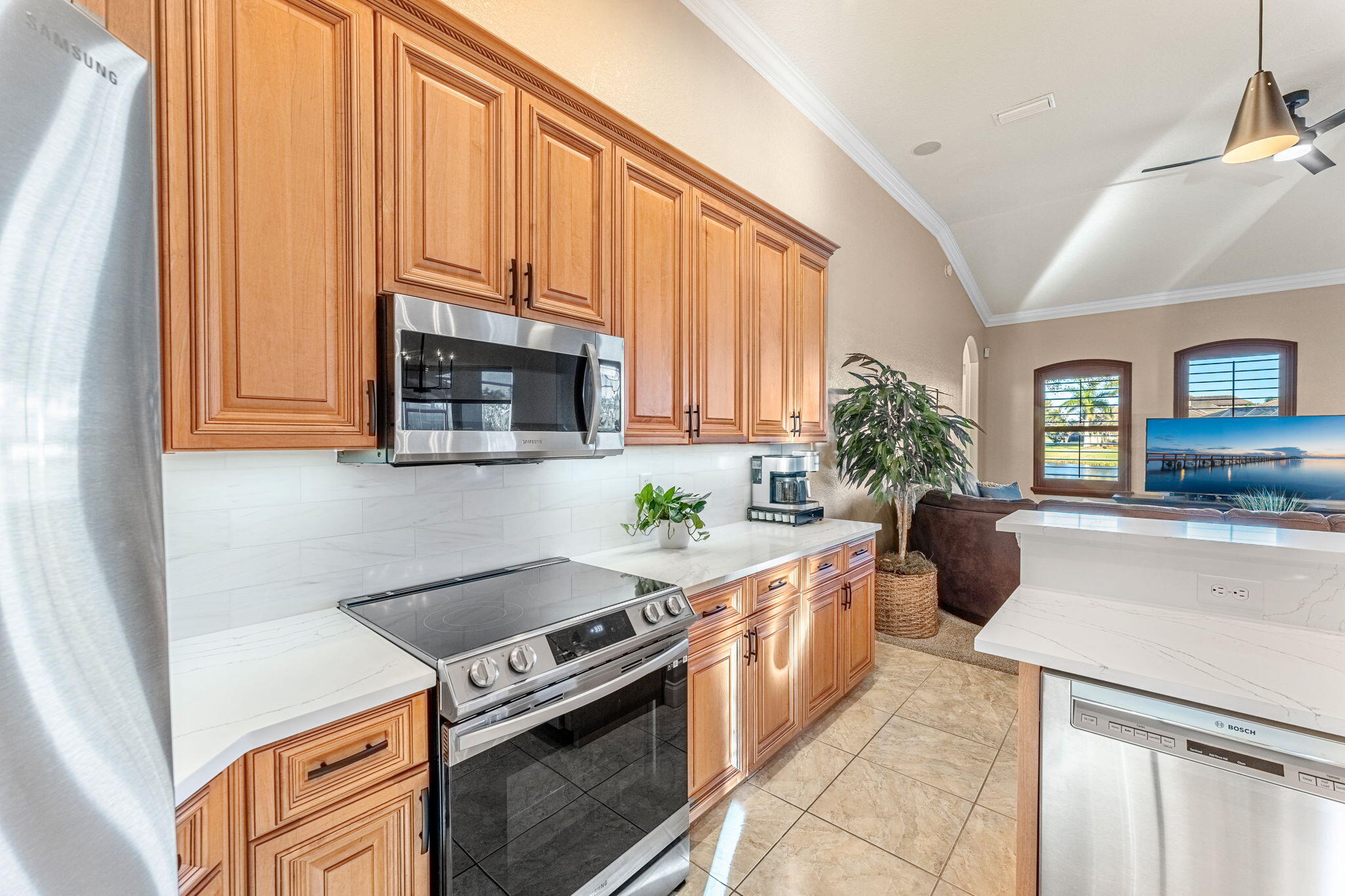 5139 Duson Way Rockledge, FL 32955 - Photo 5 of 48 a kitchen with stainless steel appliances granite countertop a stove a sink and a microwave