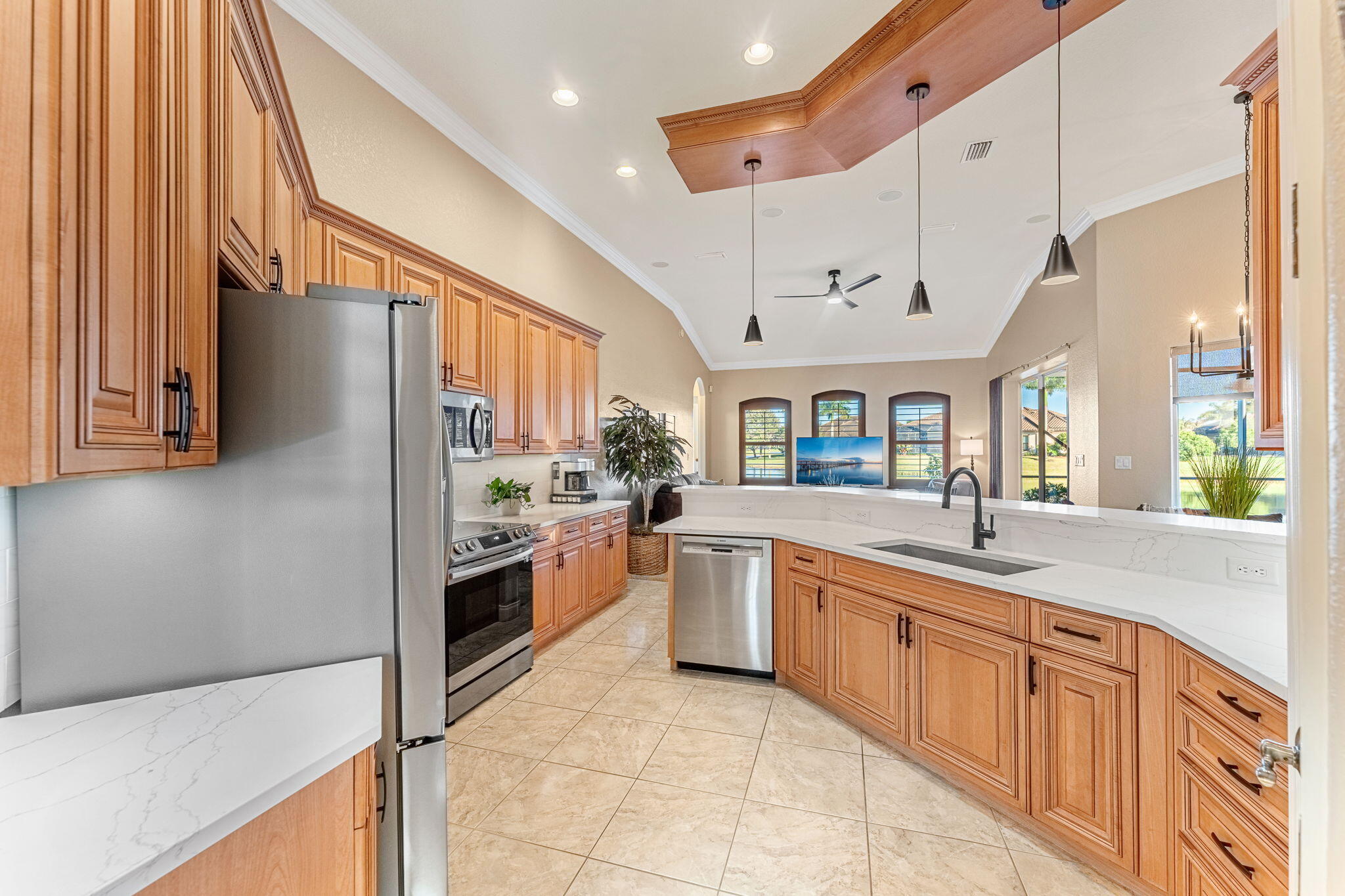 5139 Duson Way Rockledge, FL 32955 - Photo 6 of 48 a large white kitchen with stainless steel appliances granite countertop a refrigerator a sink and white cabinets