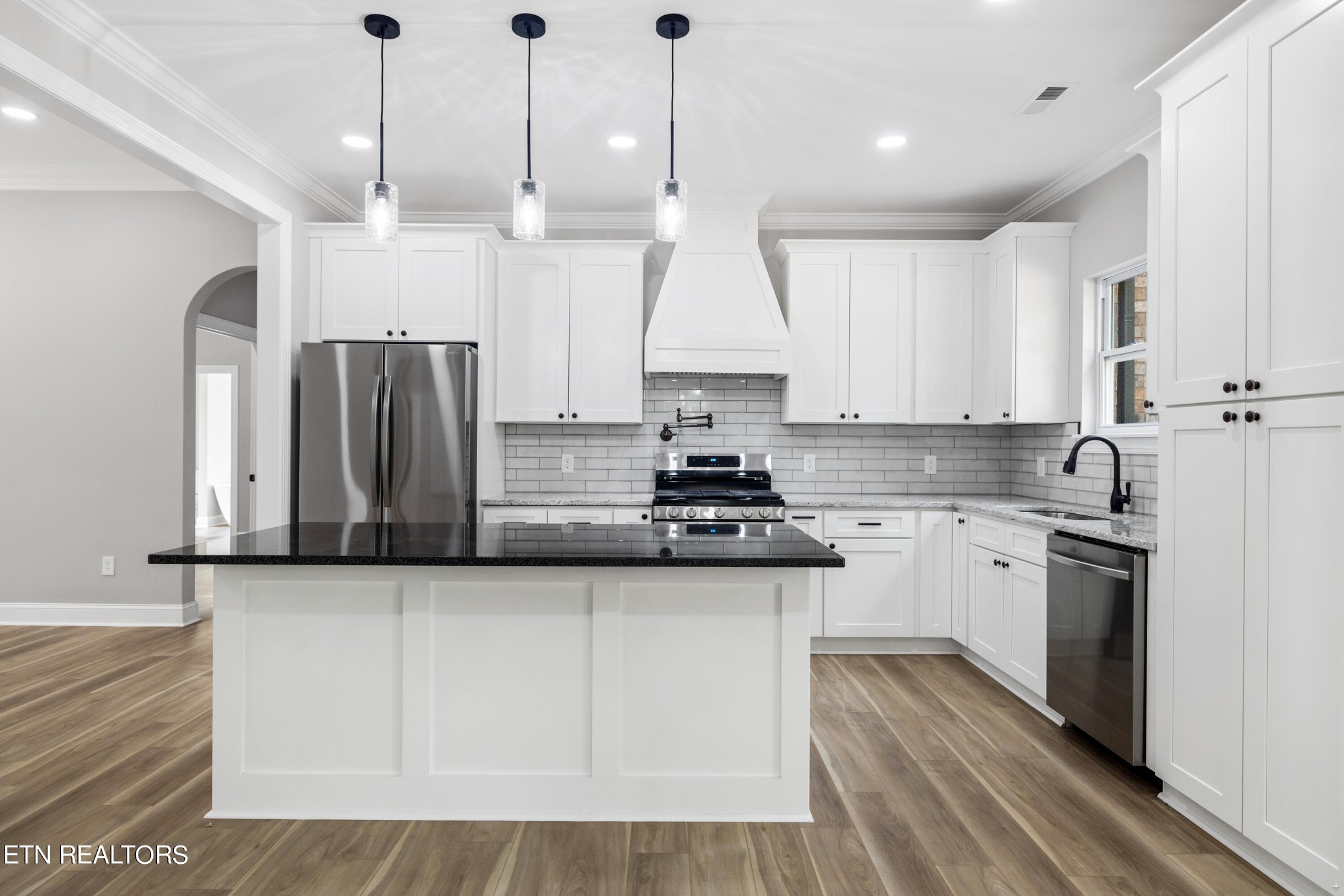 2333 Mountain View Road Lenoir City, TN 37771 - Photo 13 of 54 a kitchen with stainless steel appliances granite countertop a sink a stove a refrigerator and island with wooden floor