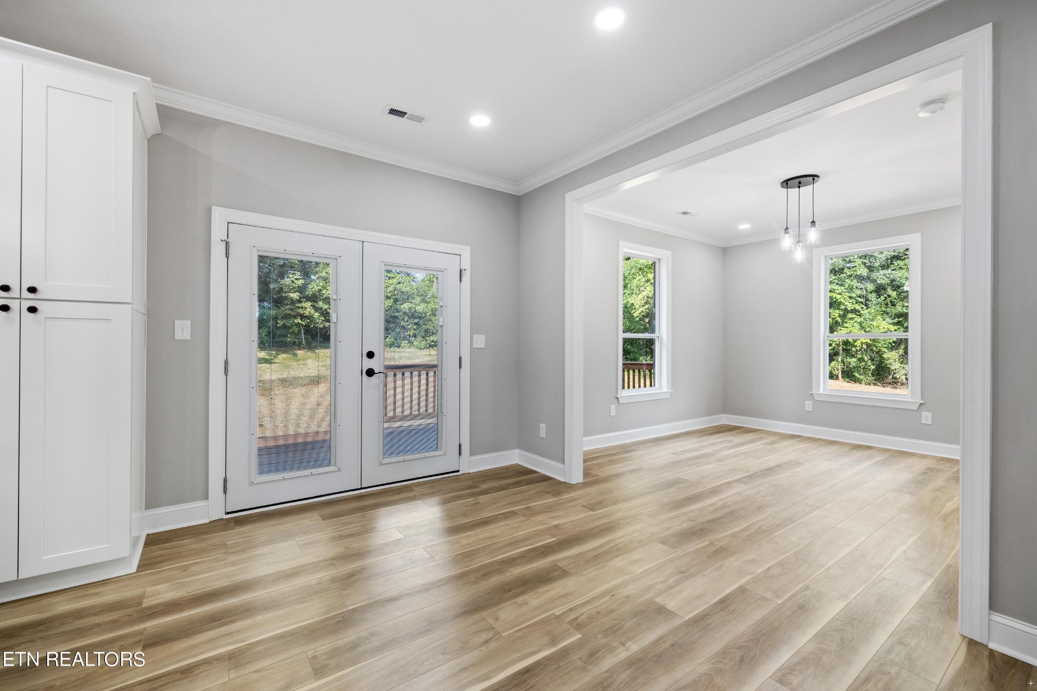 2333 Mountain View Road Lenoir City, TN 37771 - Photo 16 of 54 an empty room with wooden floor and windows