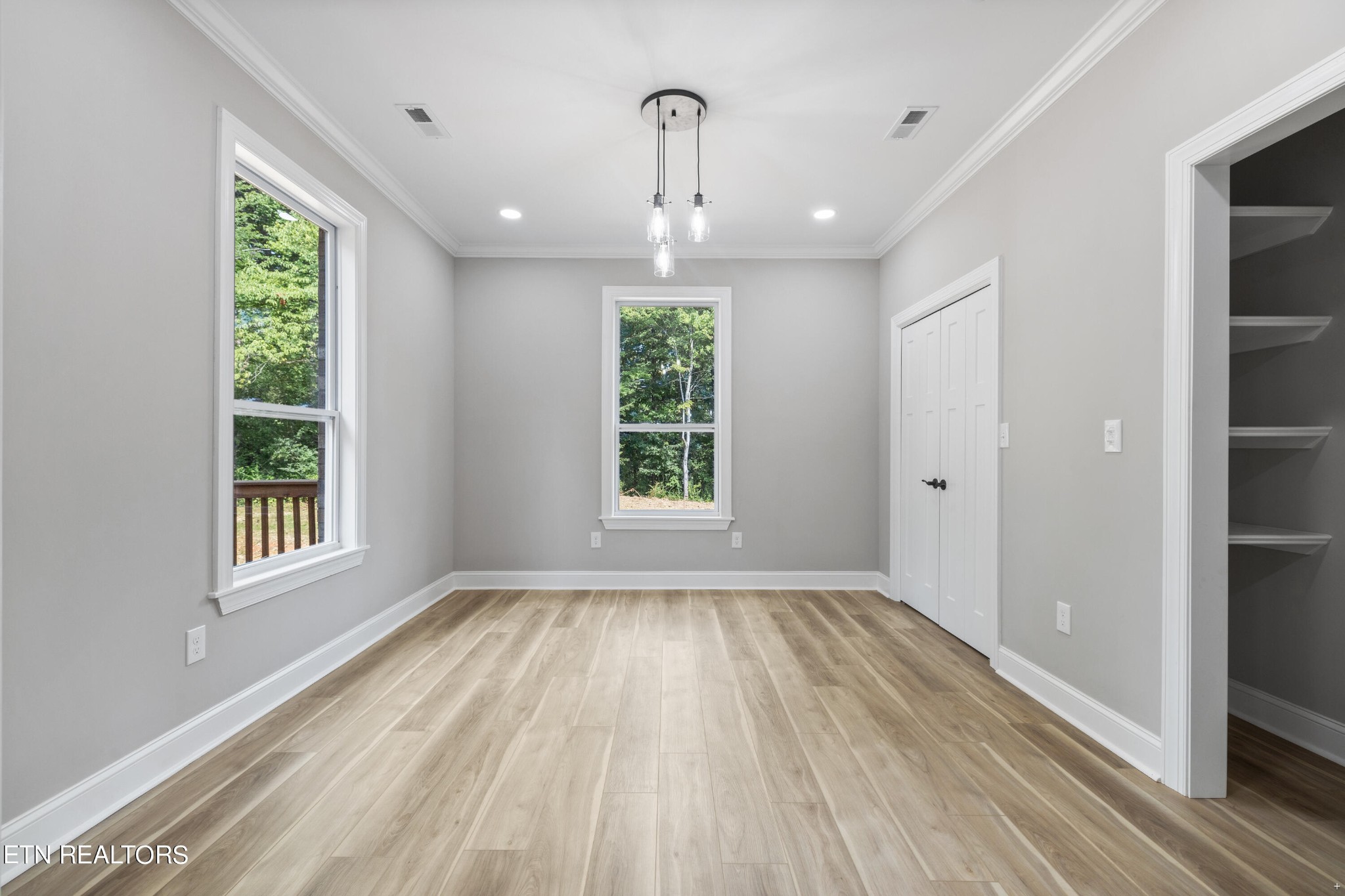 2333 Mountain View Road Lenoir City, TN 37771 - Photo 18 of 54 a view of an empty room with wooden floor and a window