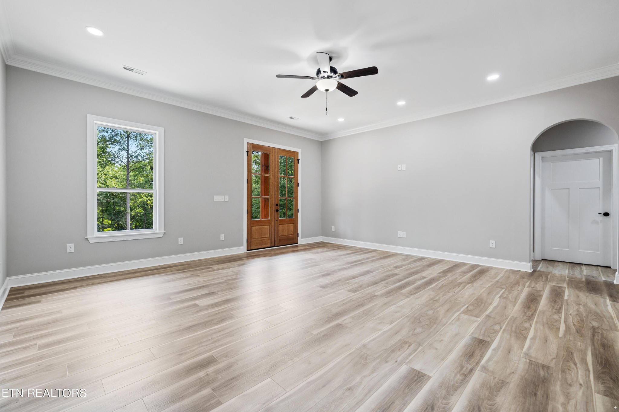 2333 Mountain View Road Lenoir City, TN 37771 - Photo 21 of 54 an empty room with wooden floor chandelier fan and windows