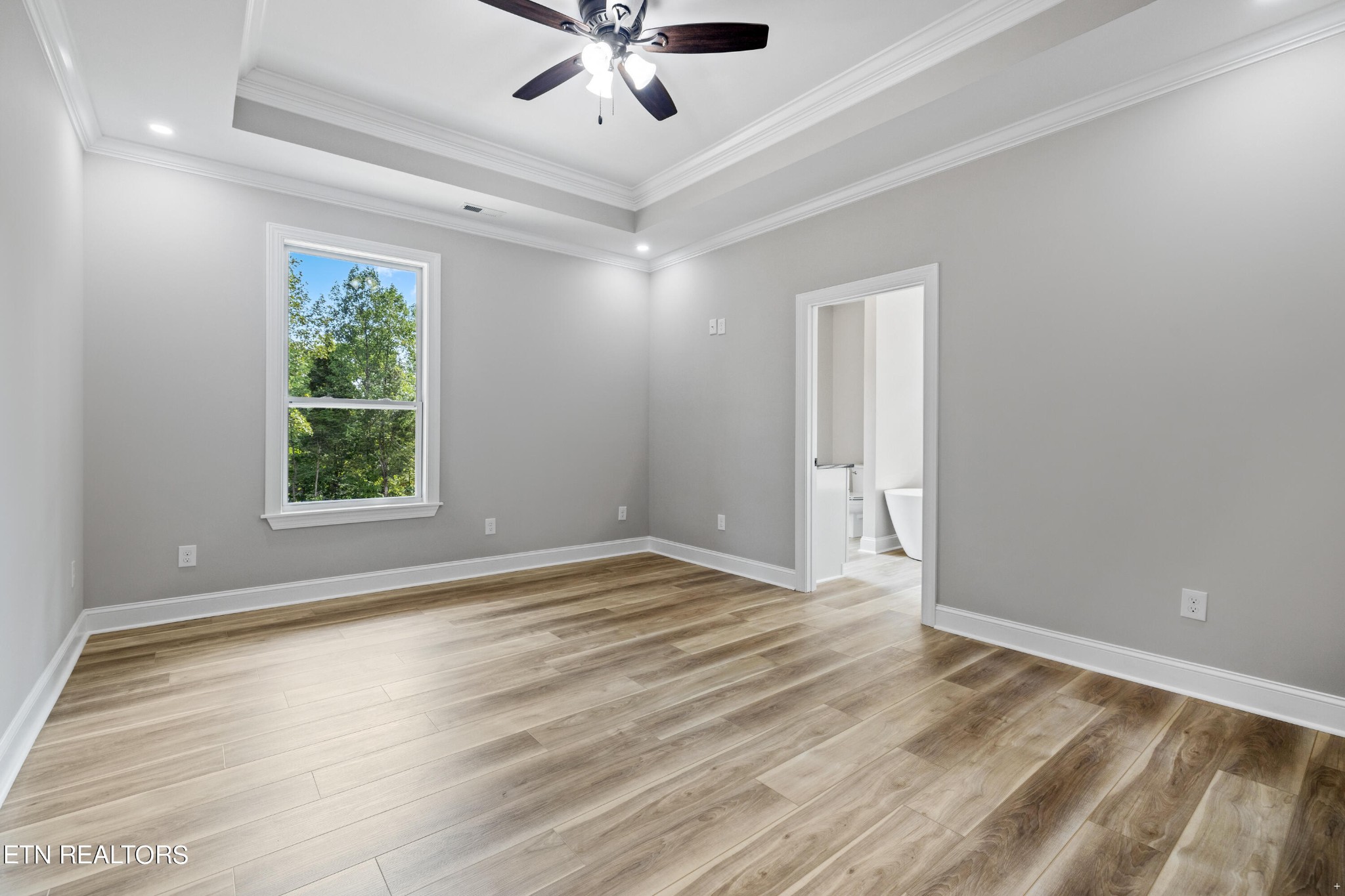 2333 Mountain View Road Lenoir City, TN 37771 - Photo 22 of 54 a view of an empty room with wooden floor and a window
