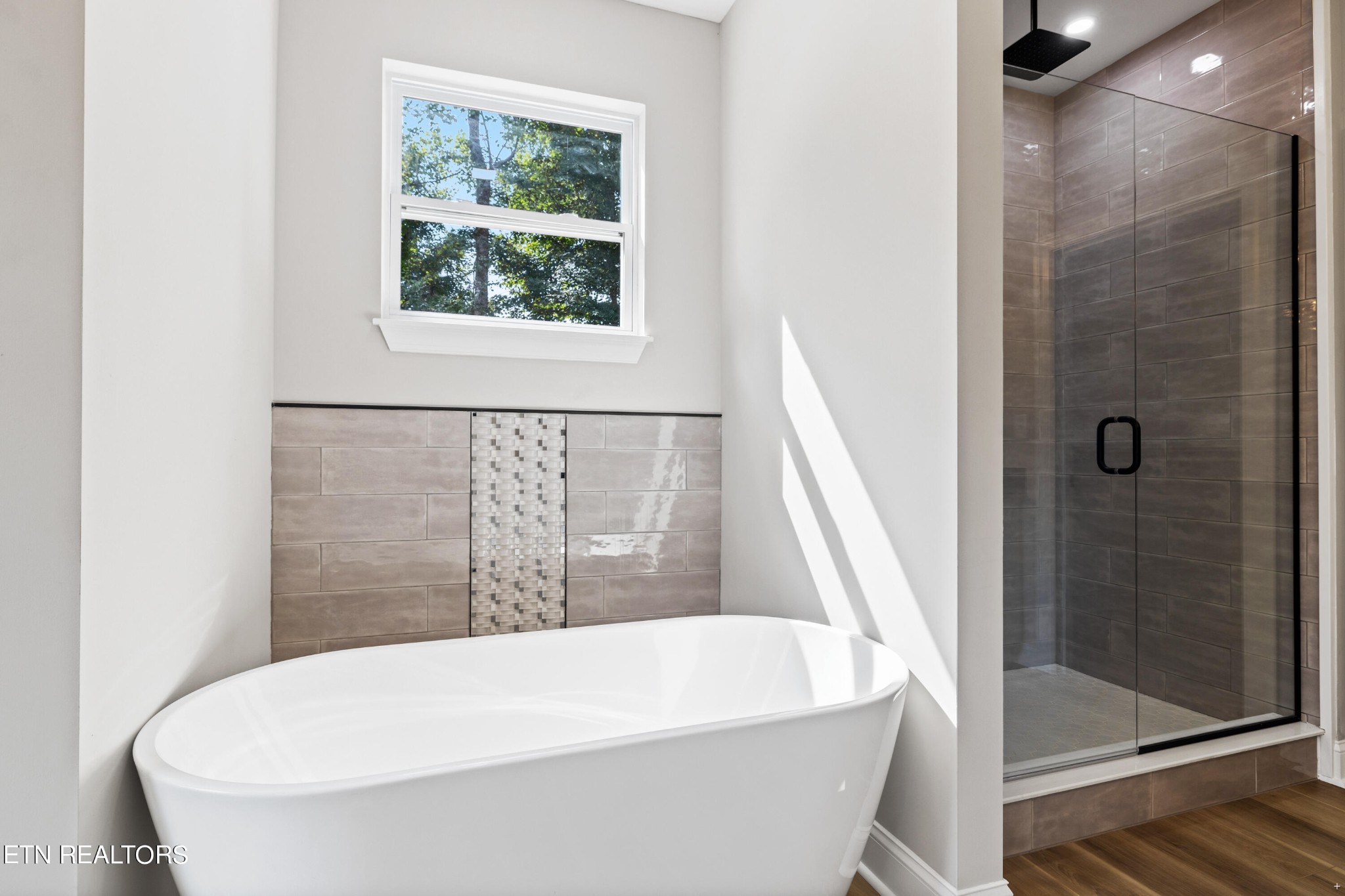 2333 Mountain View Road Lenoir City, TN 37771 - Photo 24 of 54 a white bath tub sitting in a bathroom next to a window