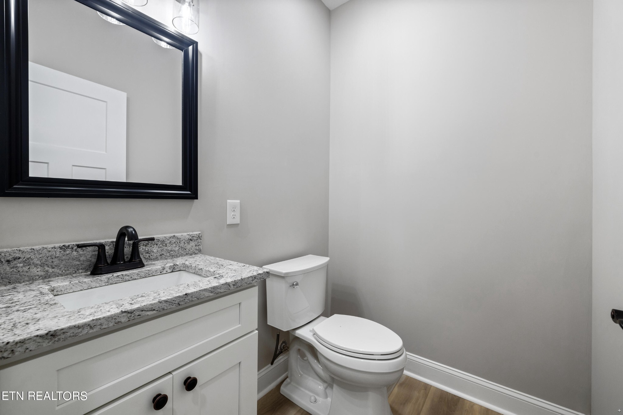 2333 Mountain View Road Lenoir City, TN 37771 - Photo 29 of 54 a bathroom with a granite countertop toilet sink and mirror