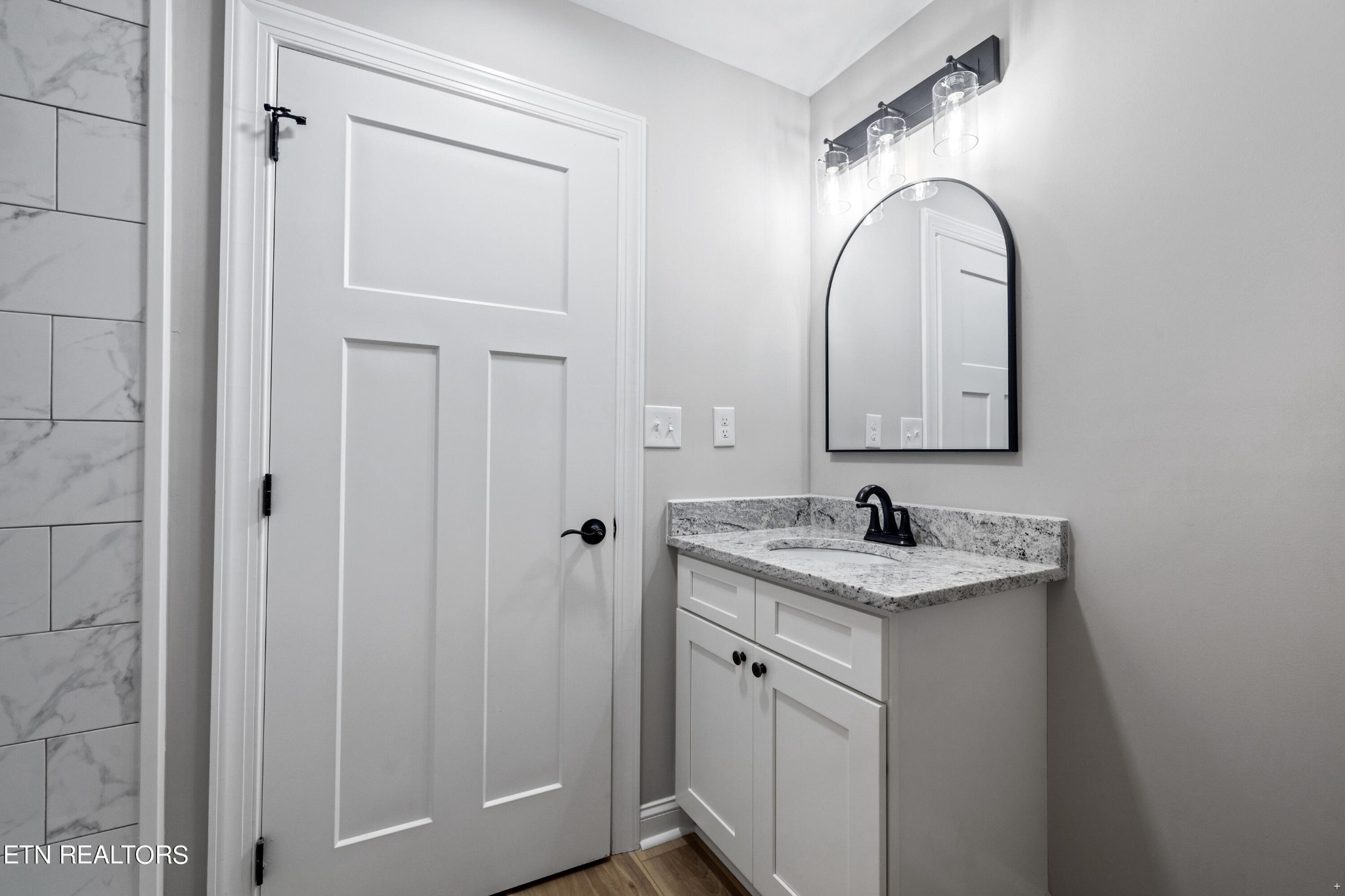 2333 Mountain View Road Lenoir City, TN 37771 - Photo 35 of 54 a bathroom with a granite countertop sink a mirror and shower
