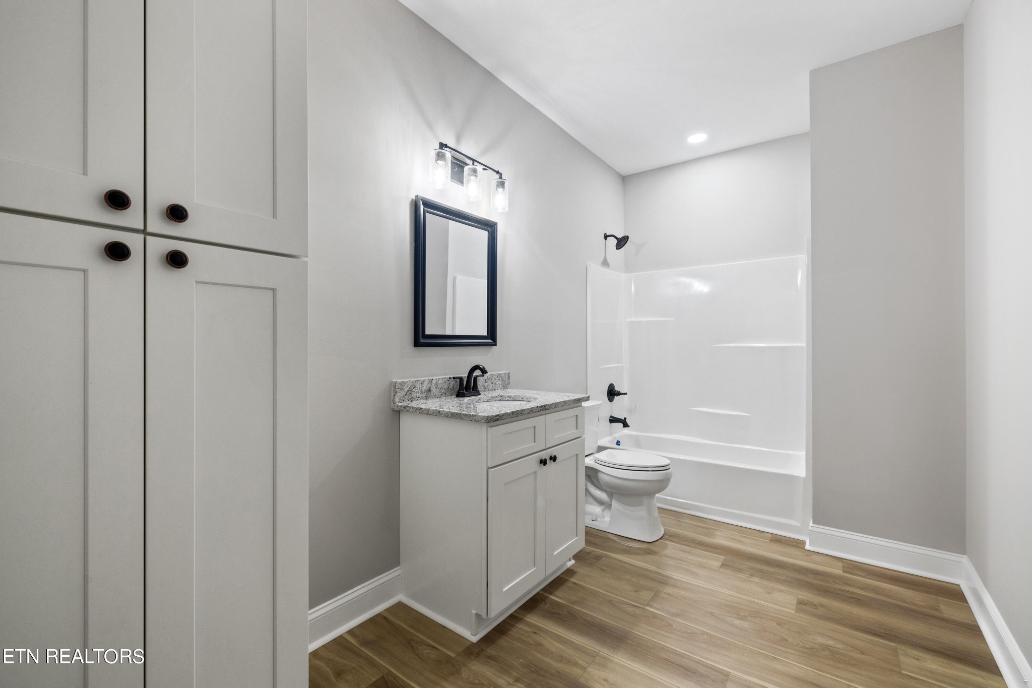 2333 Mountain View Road Lenoir City, TN 37771 - Photo 45 of 54 a bathroom with a toilet a sink and mirror