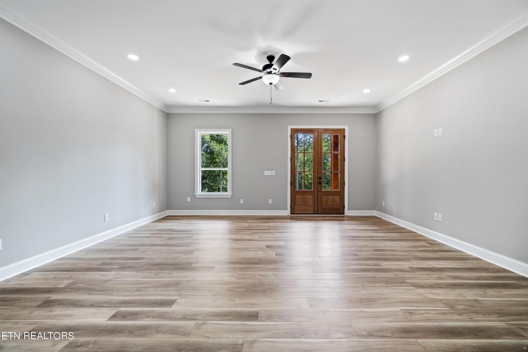 2333 Mountain View Road Lenoir City, TN 37771 - Photo 10 of 54 a view of an empty room with a window and wooden floor