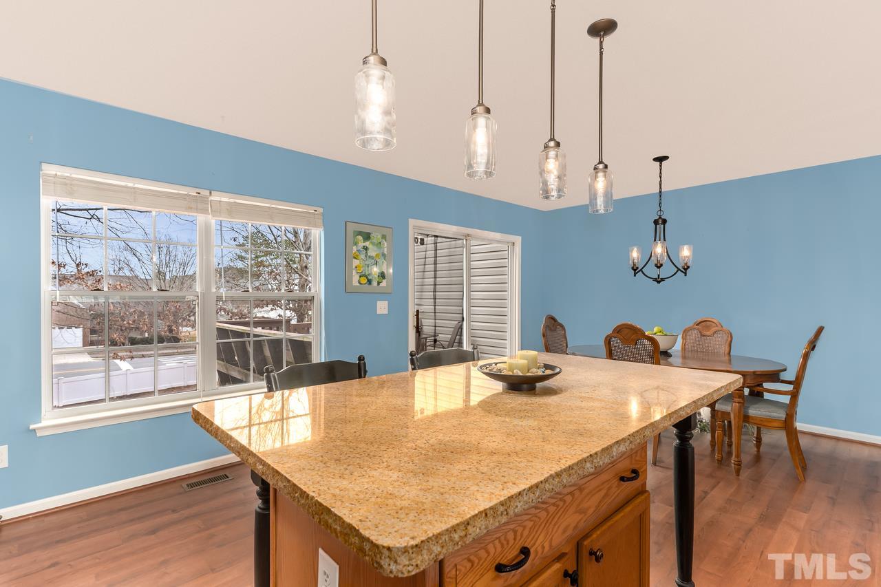 8716 Winding River Way Raleigh, NC 27616 - Photo 14 of 30 a dining room with a table or chairs and a wooden floor