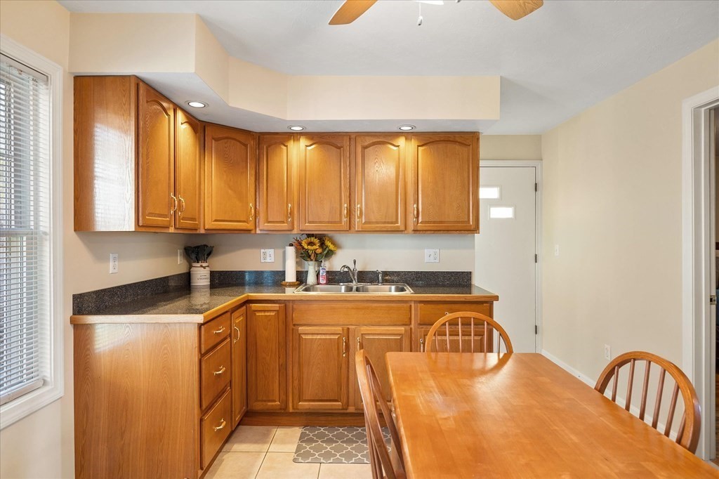20 Alpine Trail Auburn, MA 01501 - Photo 4 of 25 a kitchen with a sink a stove cabinets and a window