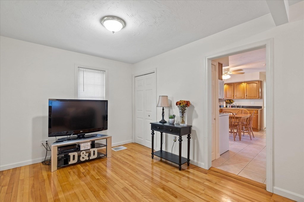 20 Alpine Trail Auburn, MA 01501 - Photo 9 of 25 a living room with furniture and a flat screen tv