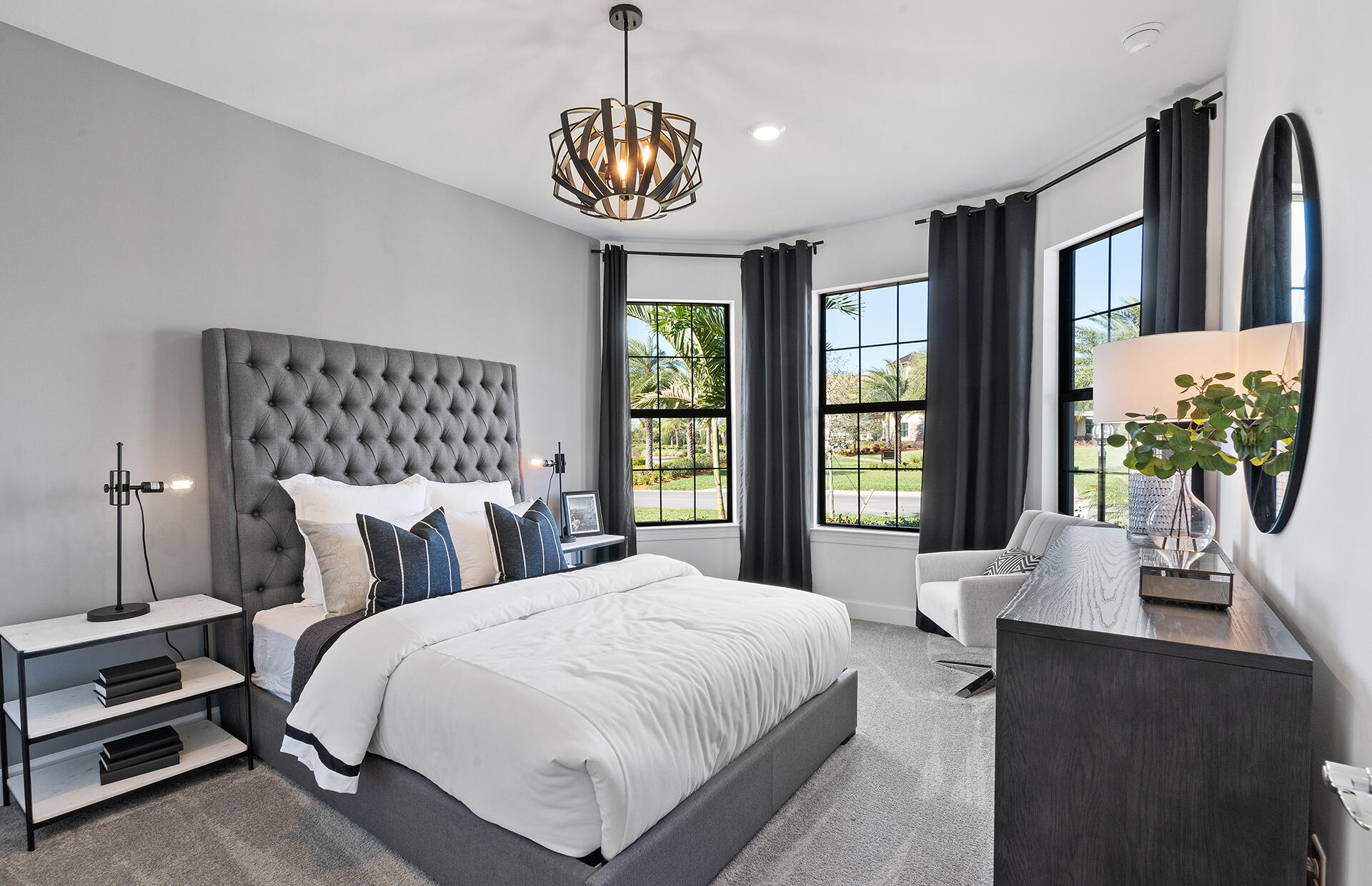 4925 Southwest Cornerstone Way, Unit MYSTIQUE 219 Stuart, FL 34997 - Photo 13 of 30 a bedroom with a large bed and a chandelier