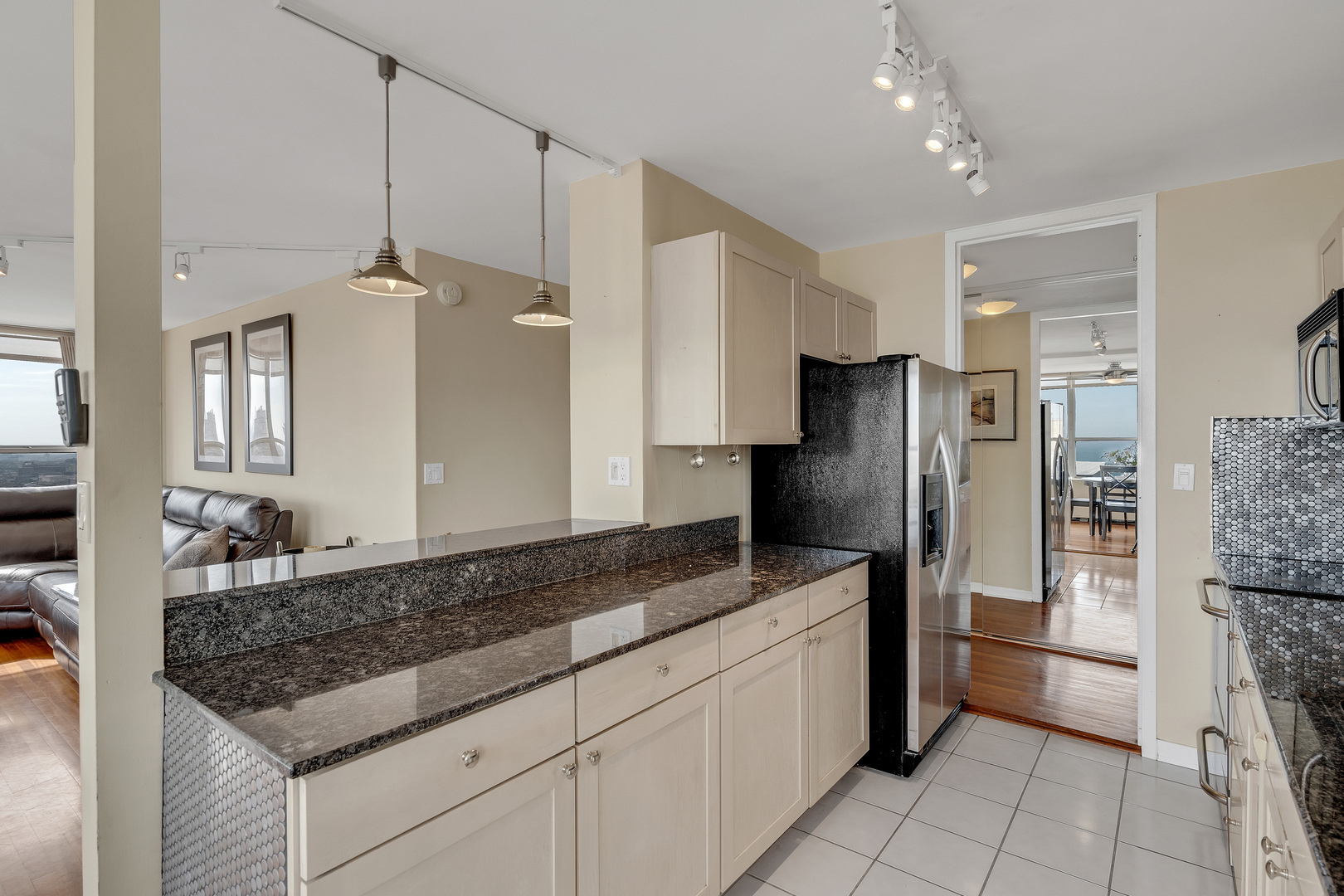 655 West Irving Park Road, Unit 2401 Chicago, IL 60613 - Photo 11 of 32 a kitchen with stainless steel appliances granite countertop a refrigerator and a sink
