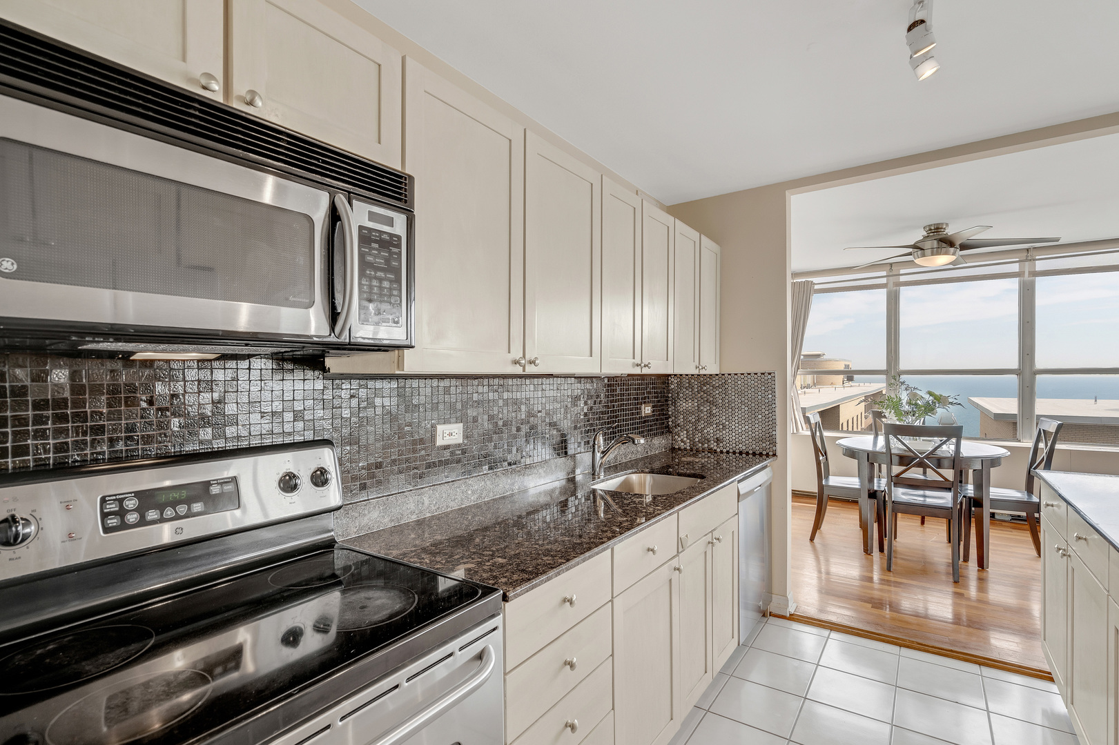 655 West Irving Park Road, Unit 2401 Chicago, IL 60613 - Photo 12 of 32 a kitchen with a stove a sink and cabinets