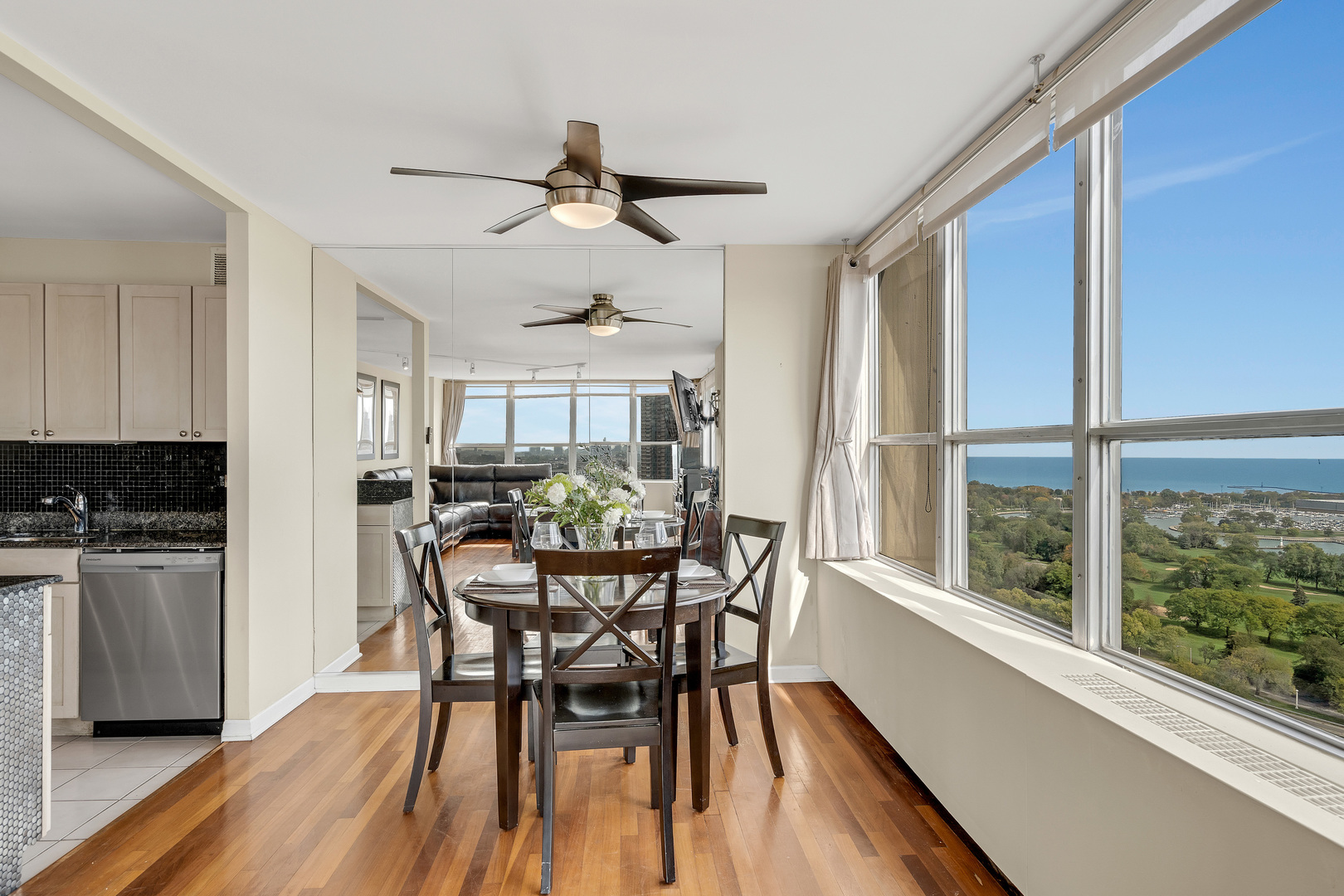 655 West Irving Park Road, Unit 2401 Chicago, IL 60613 - Photo 13 of 32 a view of a dining room with furniture window and wooden floor
