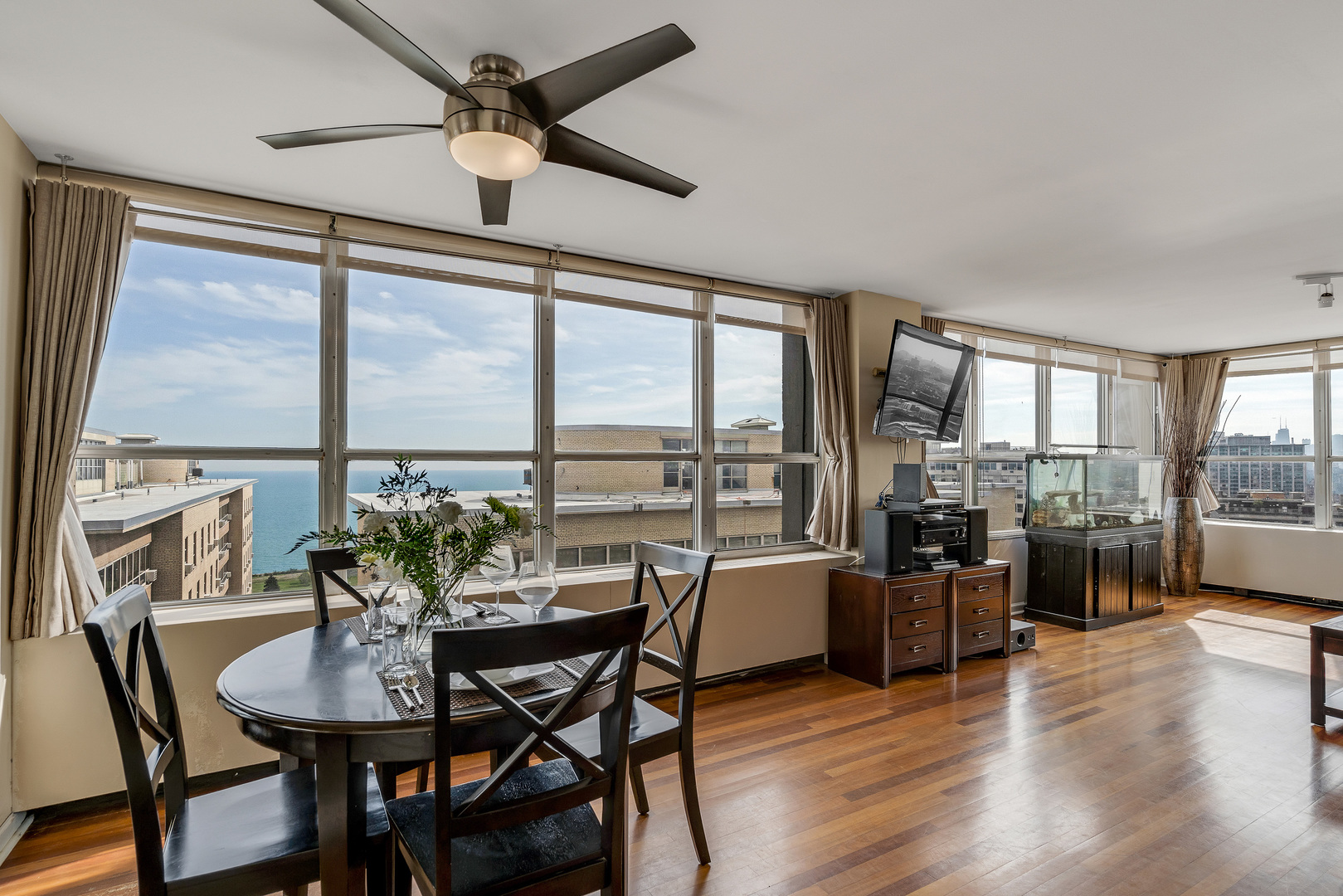 655 West Irving Park Road, Unit 2401 Chicago, IL 60613 - Photo 14 of 32 a dining room with furniture window and wooden floor
