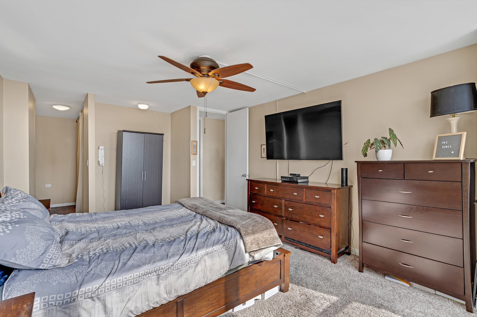 655 West Irving Park Road, Unit 2401 Chicago, IL 60613 - Photo 18 of 32 a bedroom with a bed and a flat screen tv