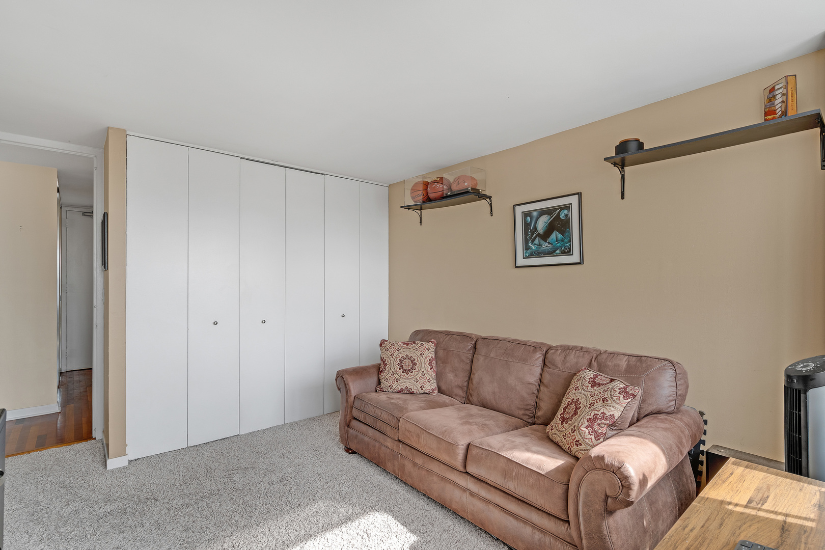 655 West Irving Park Road, Unit 2401 Chicago, IL 60613 - Photo 20 of 32 a living room with a couch and a glass door