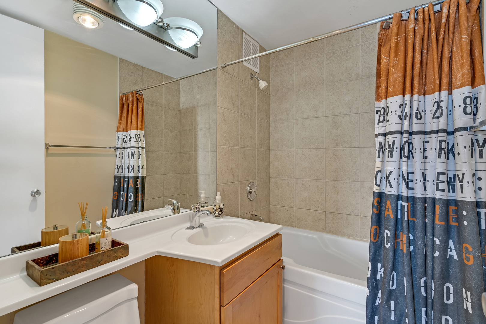 655 West Irving Park Road, Unit 2401 Chicago, IL 60613 - Photo 22 of 32 a bathroom with a sink and a mirror