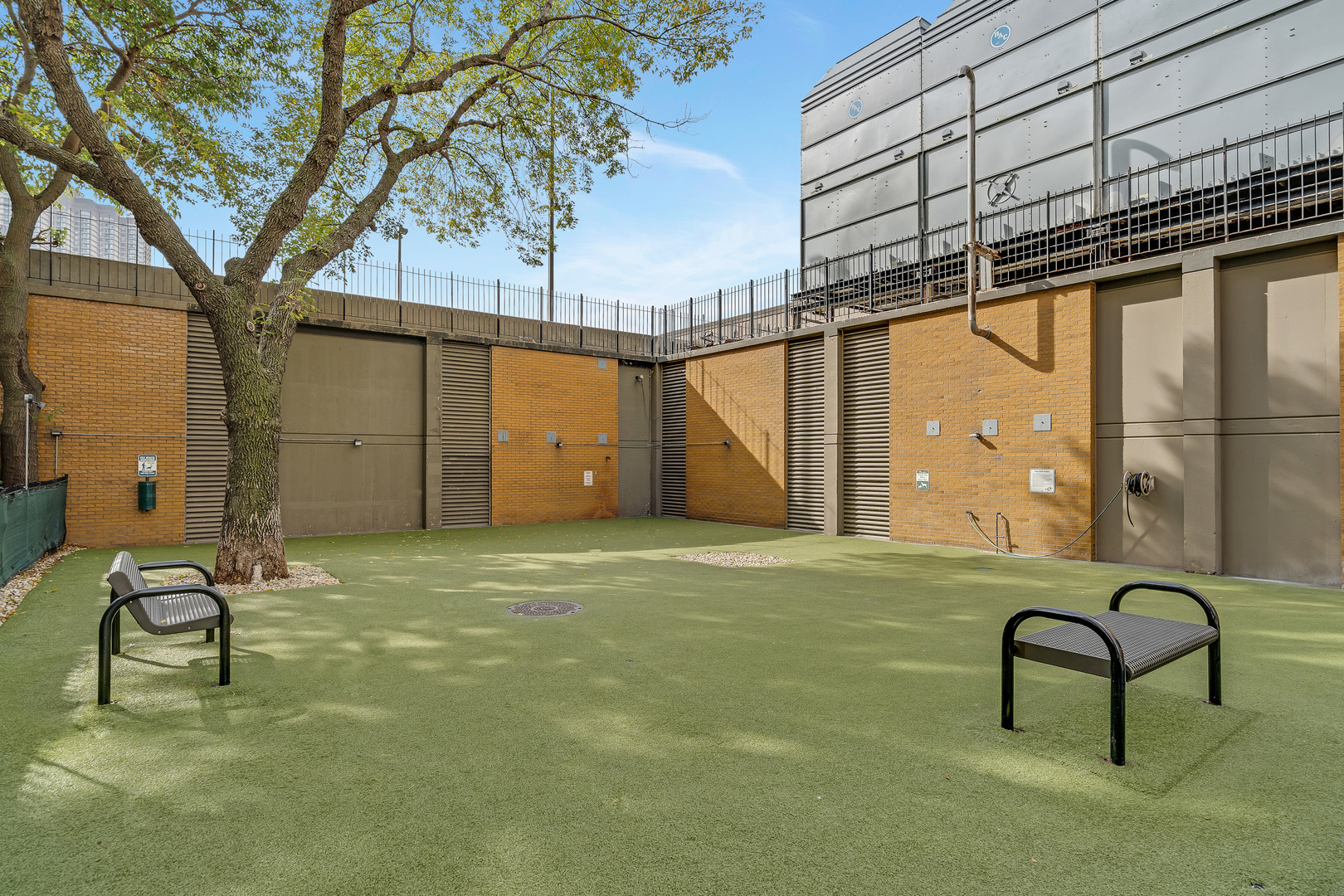 655 West Irving Park Road, Unit 2401 Chicago, IL 60613 - Photo 31 of 32 a backyard of a house with table and chairs