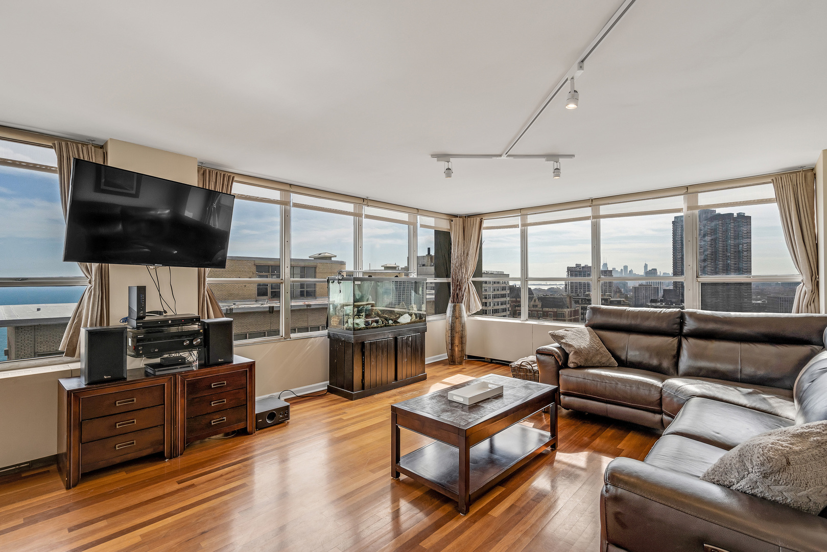 655 West Irving Park Road, Unit 2401 Chicago, IL 60613 - Photo 9 of 32 a living room with furniture and a flat screen tv