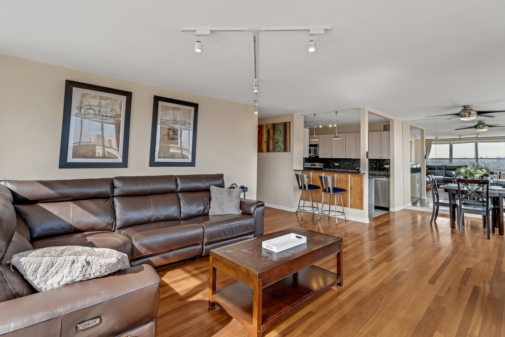655 West Irving Park Road, Unit 2401 Chicago, IL 60613 - Photo 10 of 32 a living room with furniture wooden floor and kitchen view