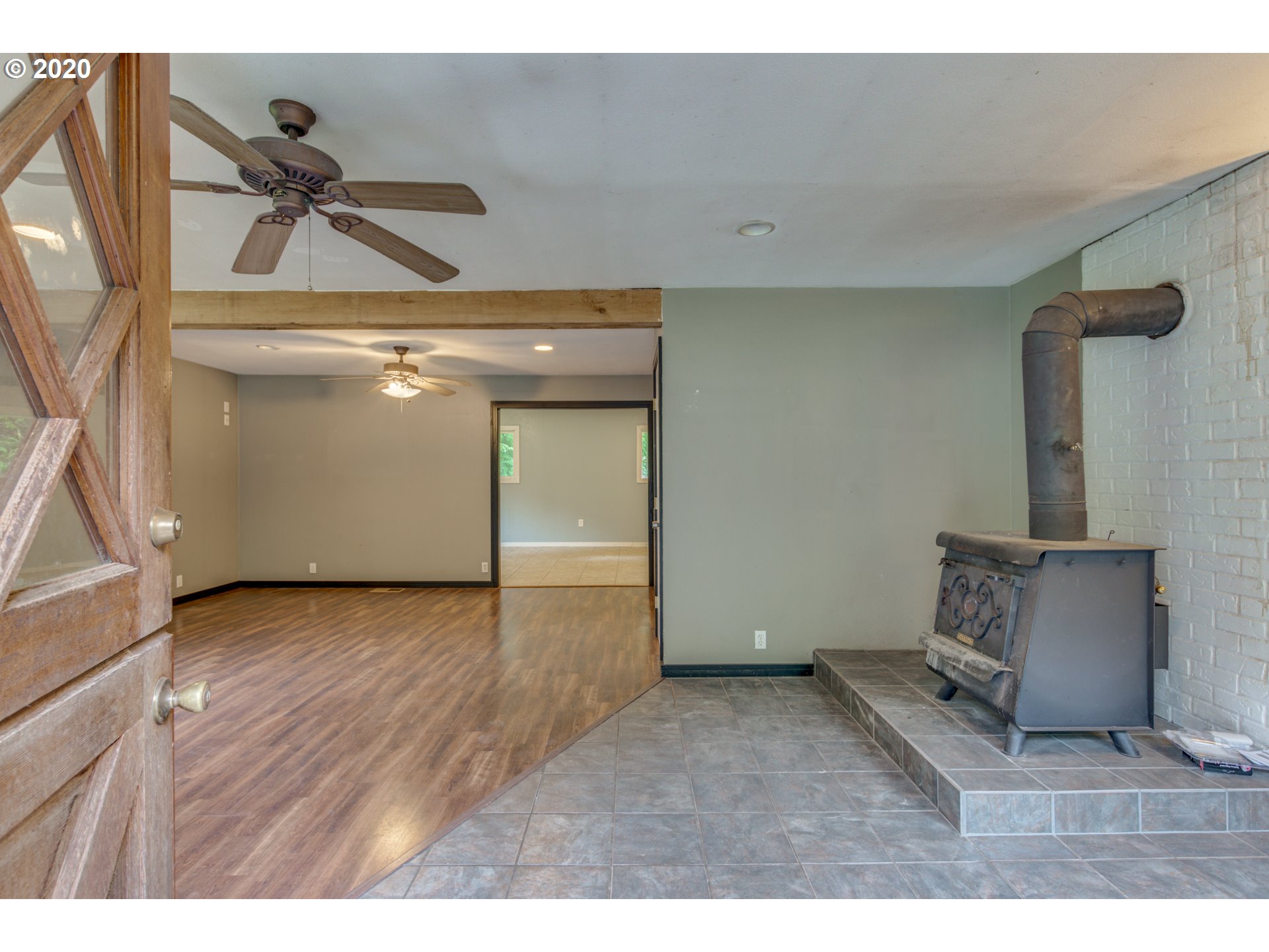 8767 Southeast Bull Run Road Corbett, OR 97019 - Photo 15 of 32 a view of a livingroom with a ceiling fan and wooden floor