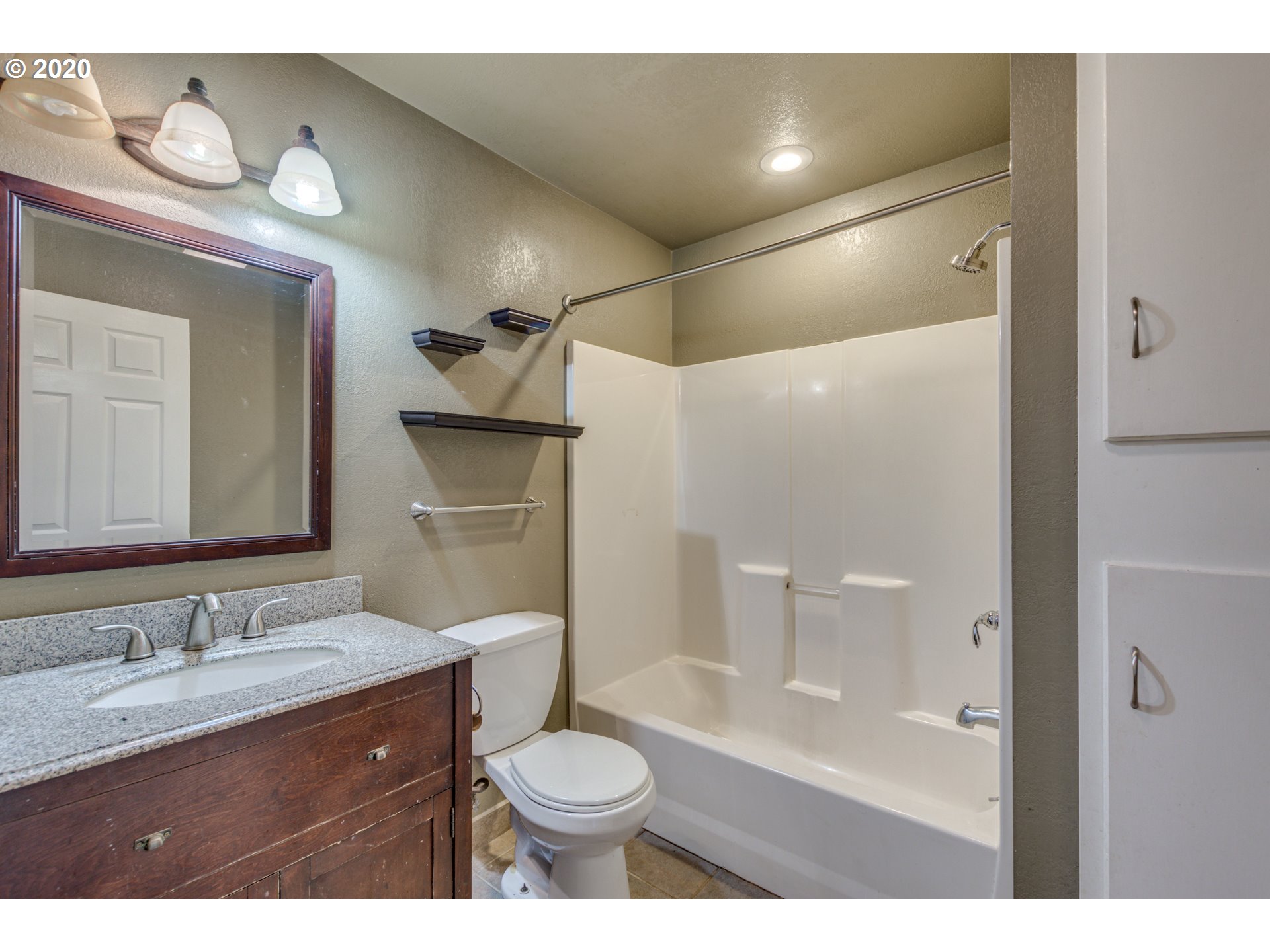 8767 Southeast Bull Run Road Corbett, OR 97019 - Photo 22 of 32 a bathroom with a granite countertop sink toilet a shower and a mirror