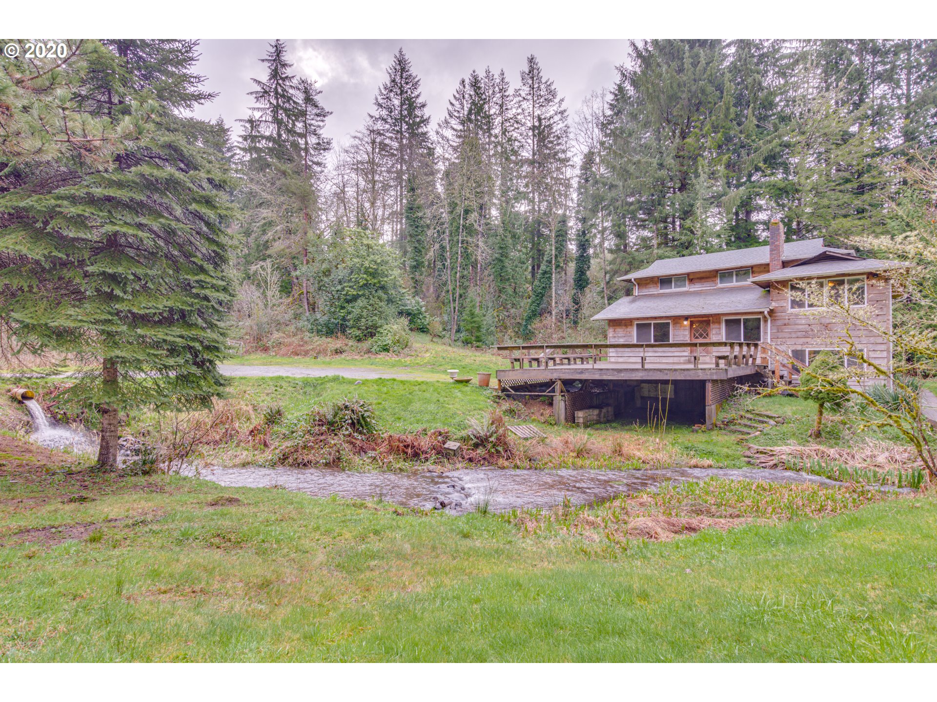 8767 Southeast Bull Run Road Corbett, OR 97019 - Photo 3 of 32 a view of house with backyard and outdoor seating