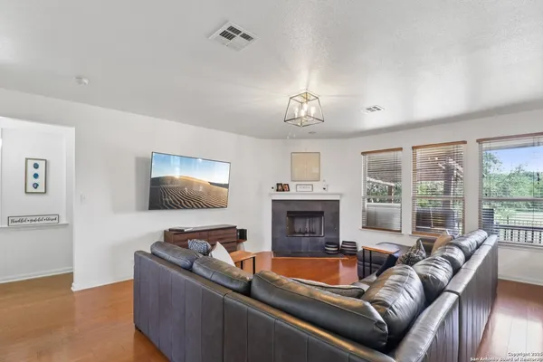 a living room with furniture fireplace and a flat screen tv