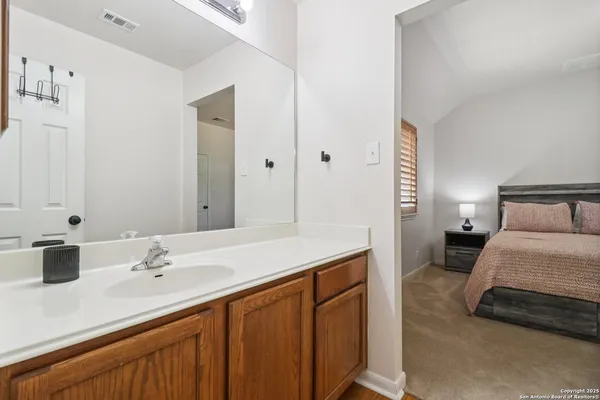 a en suite bathroom with a sink and a mirror