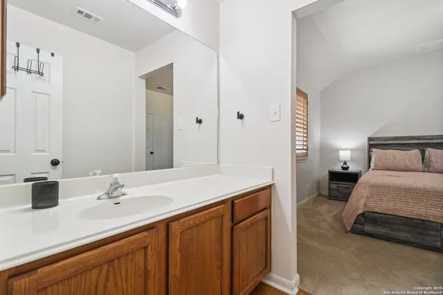 a en suite bathroom with a sink and a mirror