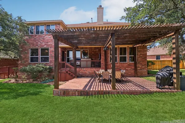 a view of a house with backyard and sitting area