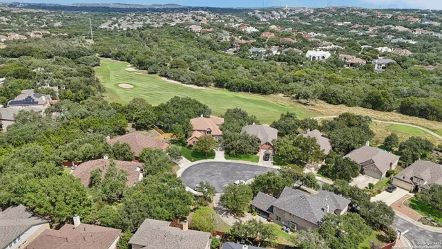 an aerial view of a residential houses with outdoor space