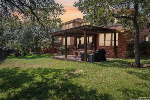 a view of a house with backyard and porch
