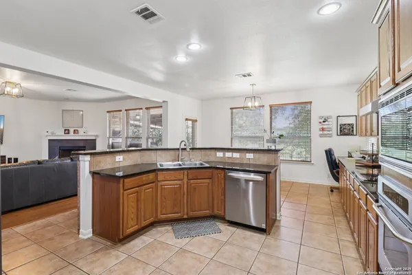 a kitchen with lots of counter furniture a sink and appliances