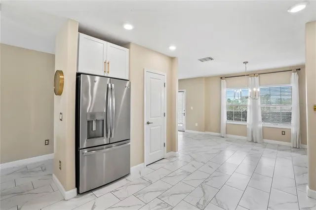 a view of a kitchen with a refrigerator and window