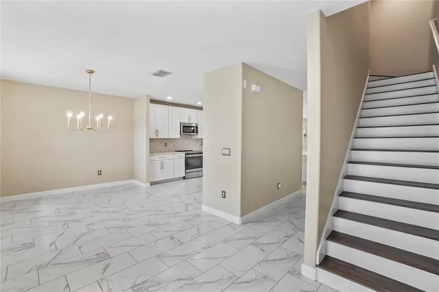 a view of a kitchen with a sink and a refrigerator